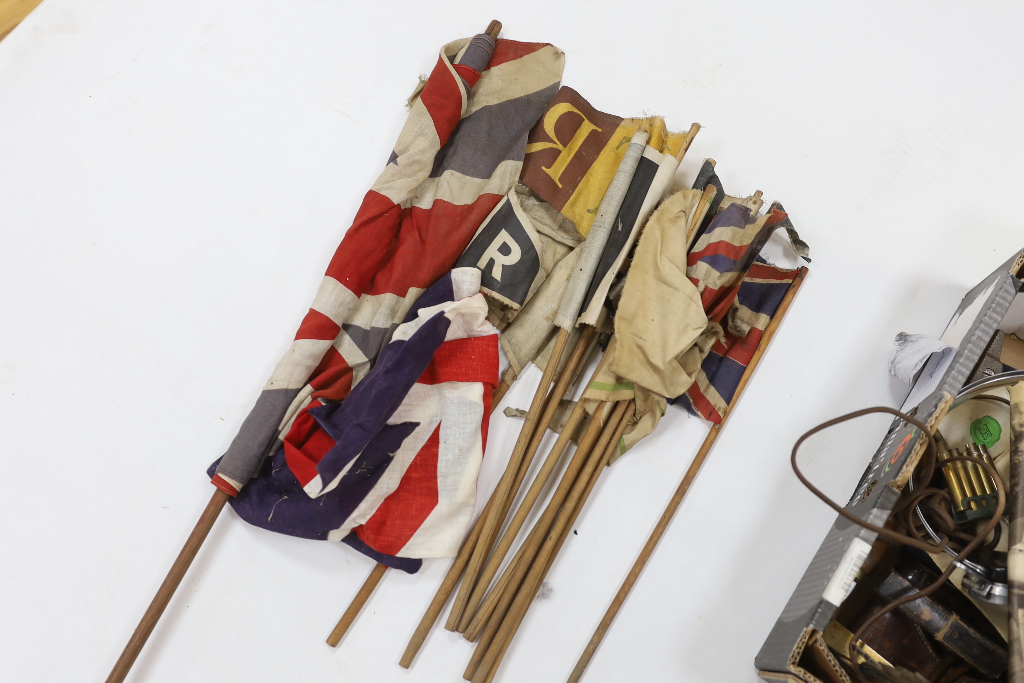 A collection of Militaria and other items, including a Royal Artillery brass cased timepiece, headphones, crepe paper bunting contained in a card Worthington’s IPA beer bottle, etc.